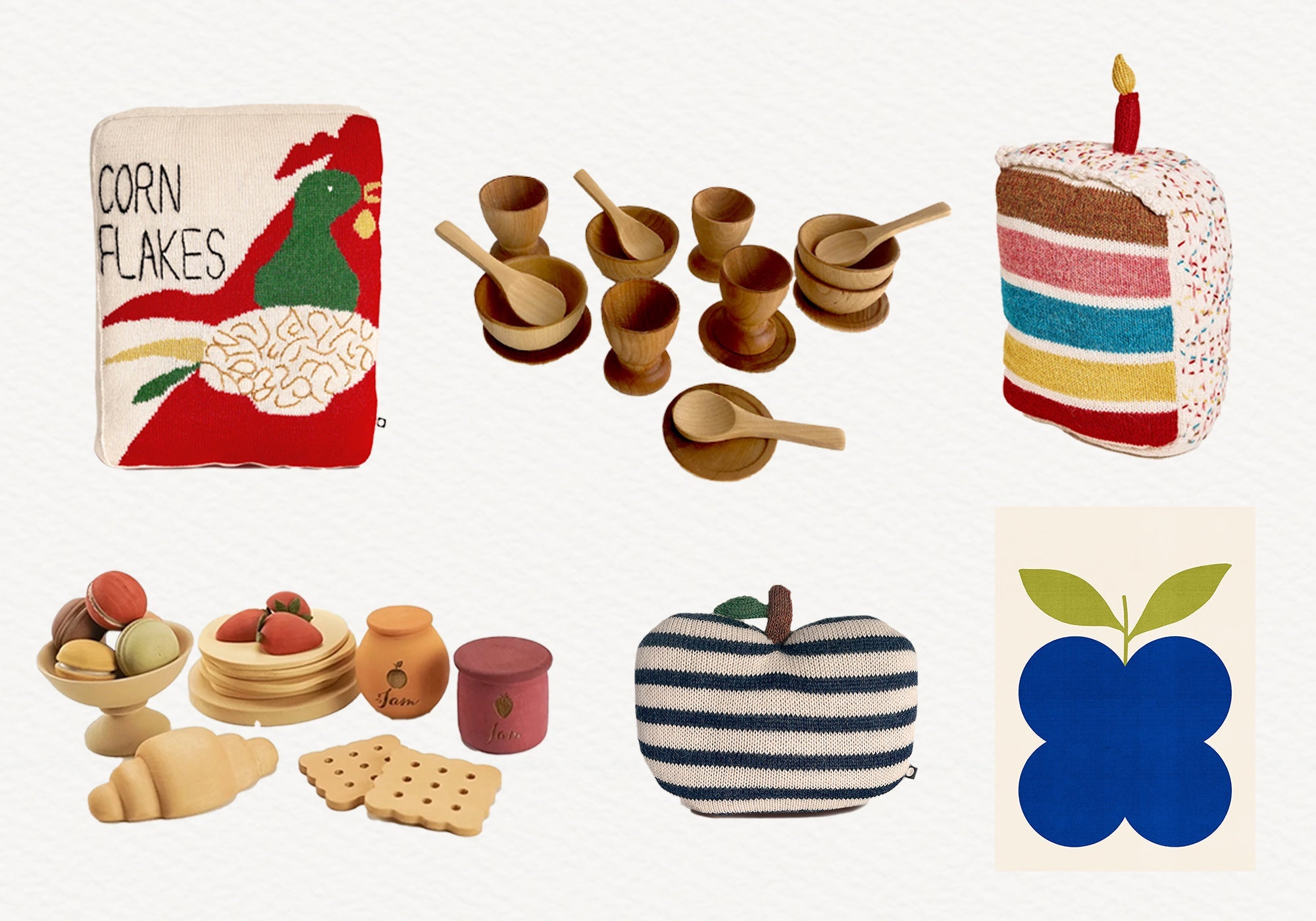 Assorted toy foods including cake, cereal box, wooden bowls, fruit, croissant, crackers, and a blue apple print.