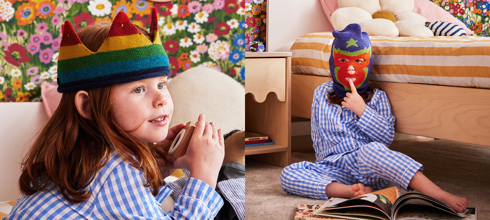 Two kids in blue checkered pajamas, one wearing a rainbow crown, the other in a colorful mask, sit in a cozy bedroom.