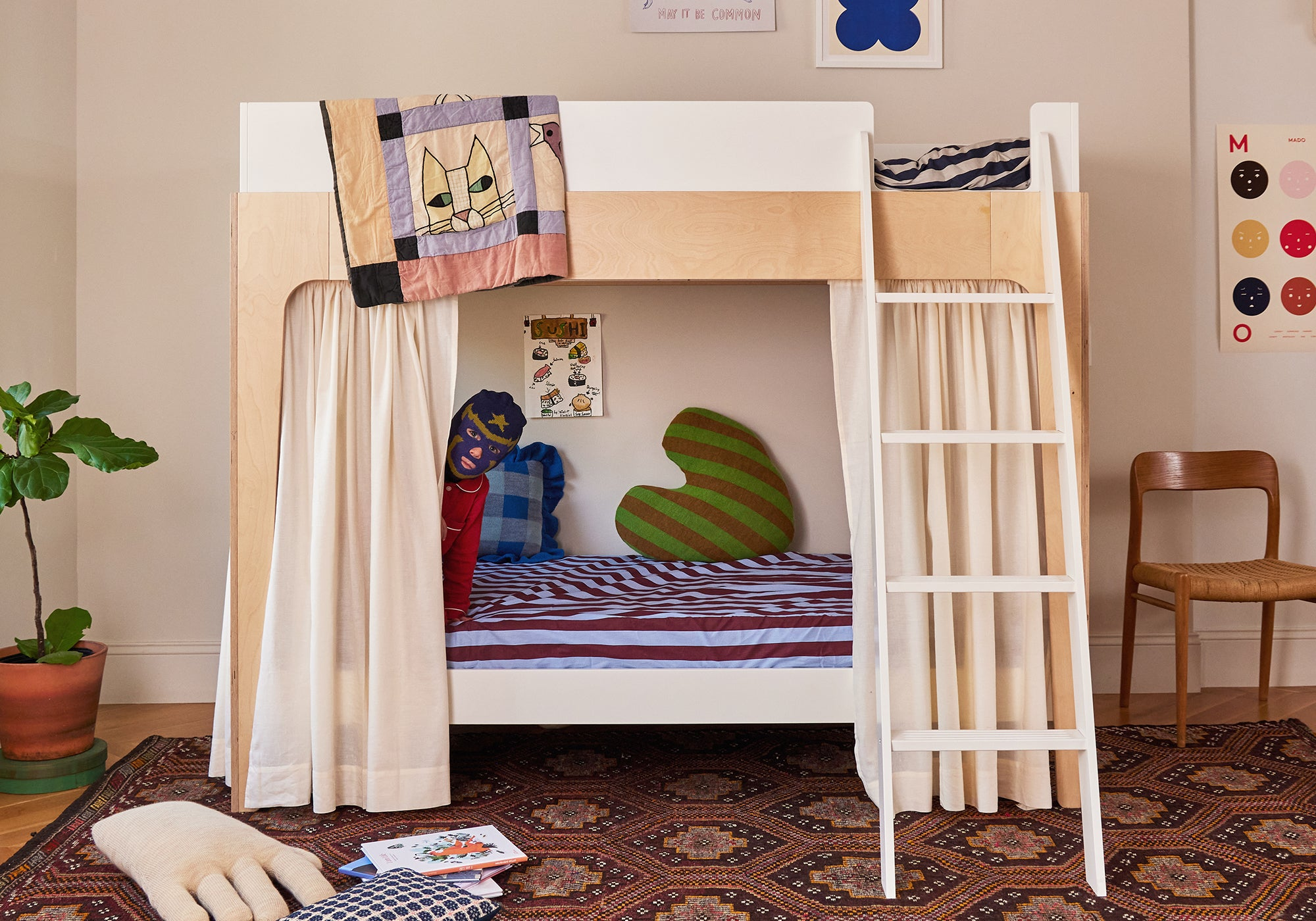 Modern wooden bunk bed with white curtains, striped bedding, heart pillow, and playful decor in a cozy room.