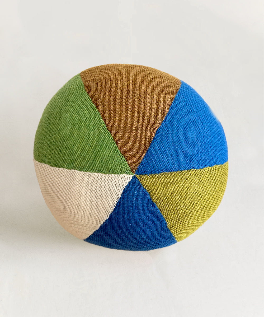 The Circus Ball - Royal Blue is a round, knitted ball featuring alternating panels of blue, green, brown, yellow, and cream.