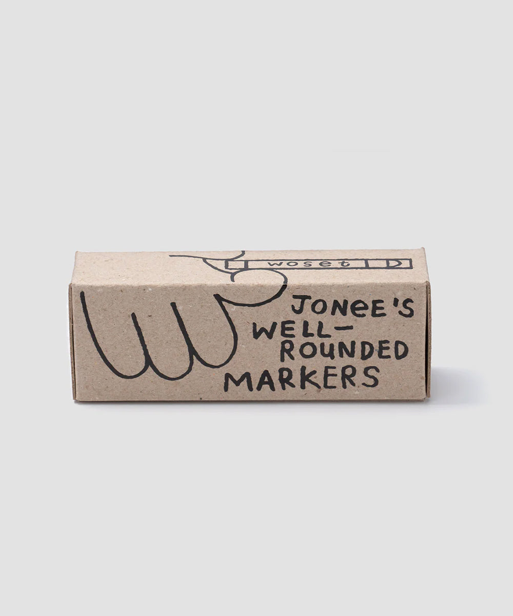 A cardboard box labeled "Le Well Rounded Markers" featuring a simple hand illustration.