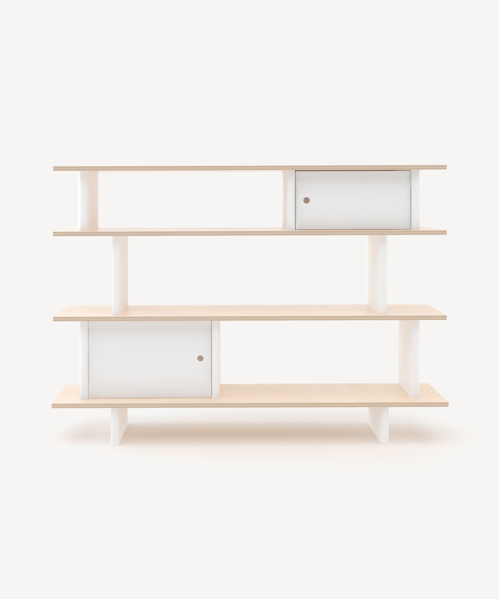The Mini Library is a minimalist light wood shelf featuring three tiers and sliding white doors on two shelves, set against a plain background.