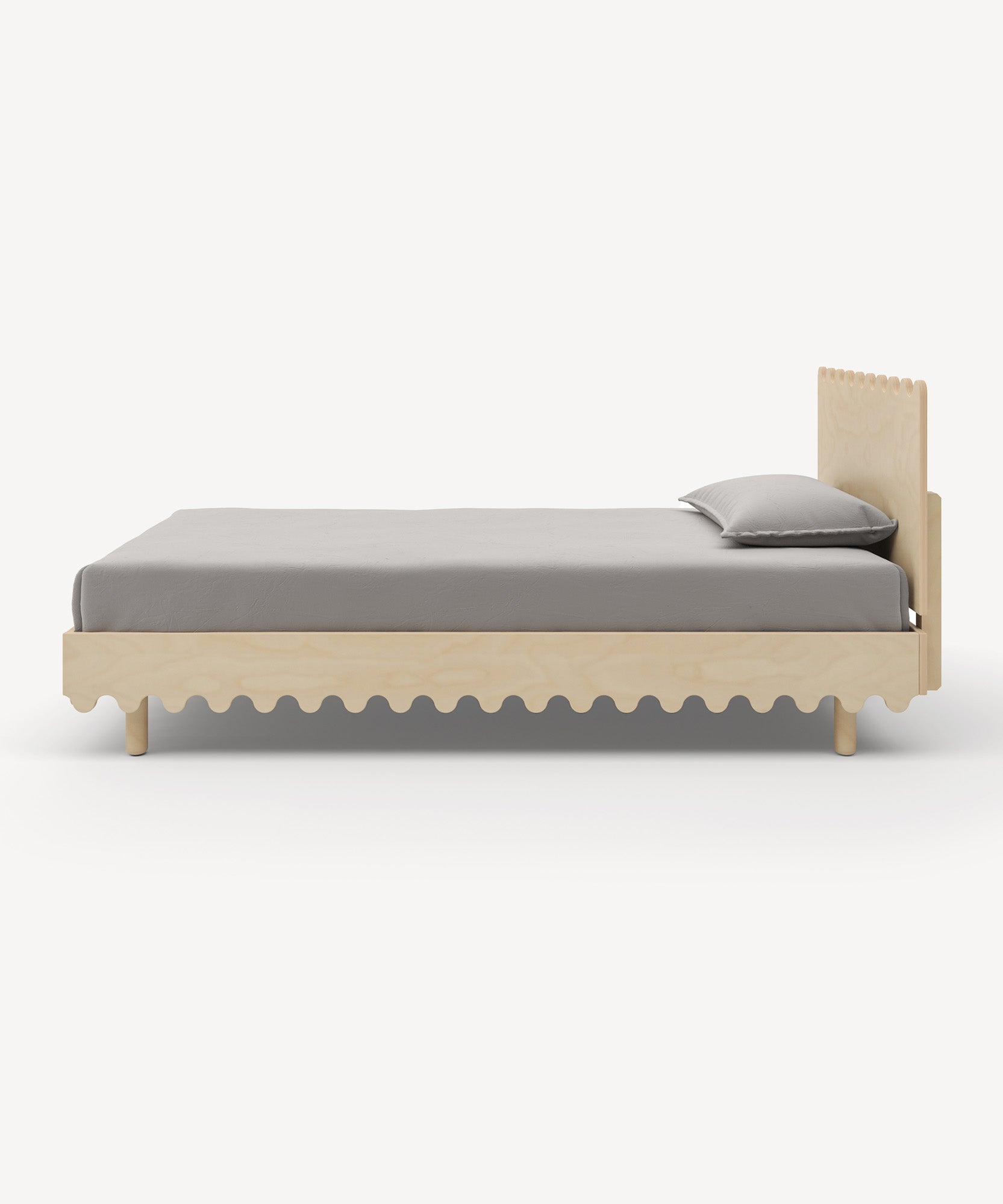 The Moss Twin Bed is minimalist with gray bedding and features a scalloped headboard and base design.