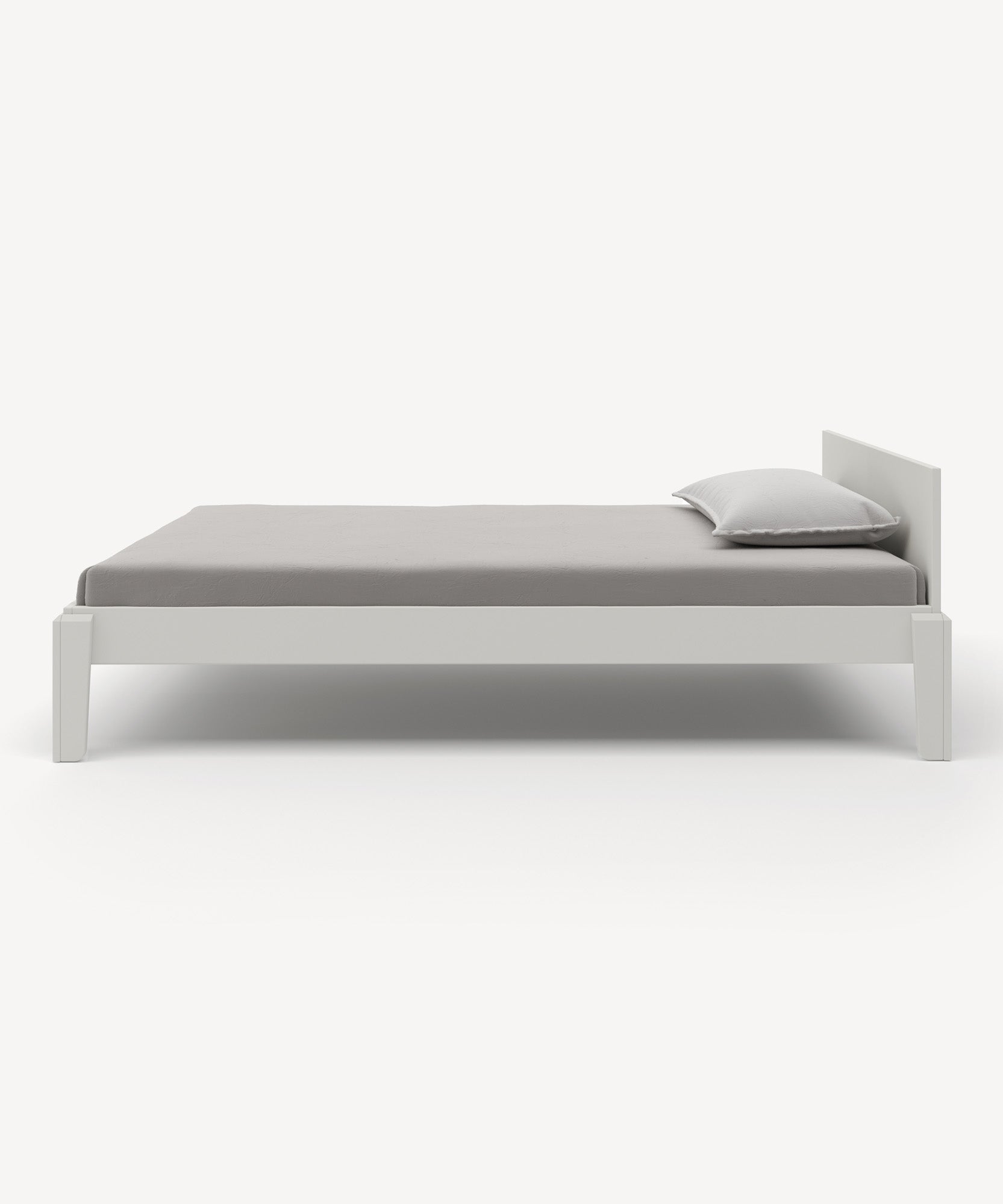 Perch Twin Bed in minimalist white with a gray mattress and a white pillow on a white background.