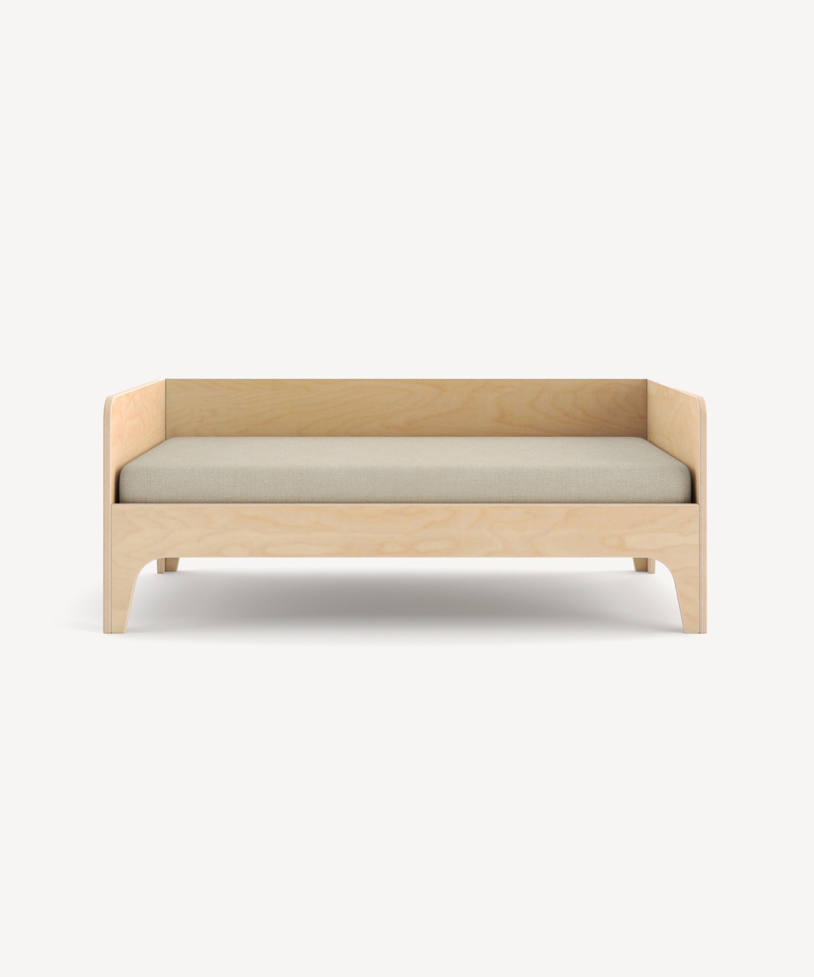 The Perch Toddler Bed features a wooden frame with a beige cushion, minimalist design, and curved legs against a plain background.