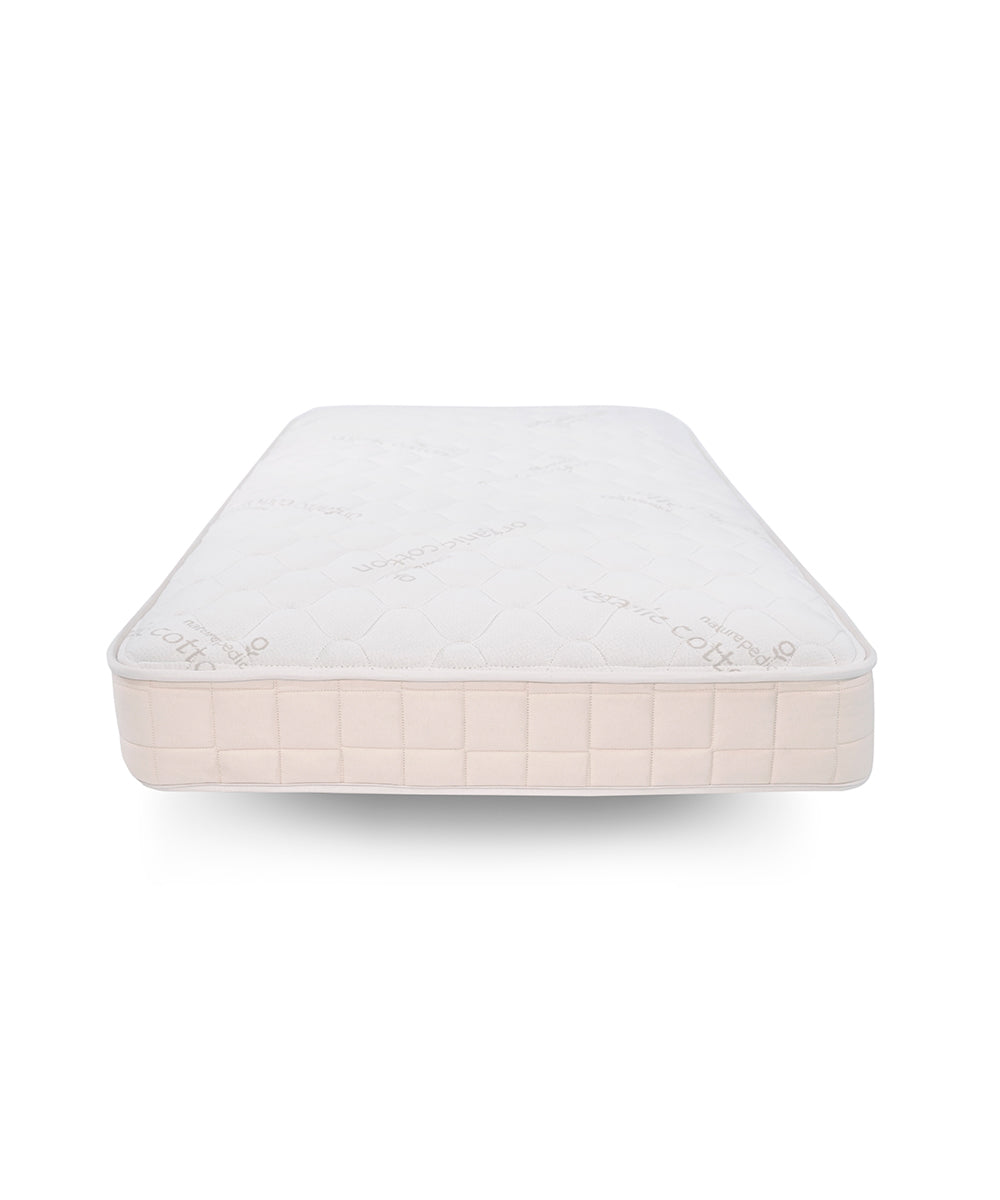 The Naturepedic 2-in-1 Organic Waterproof Mattress features a quilted, patterned white top with beige sides, displayed on a white background and viewed from the foot of the bed.
