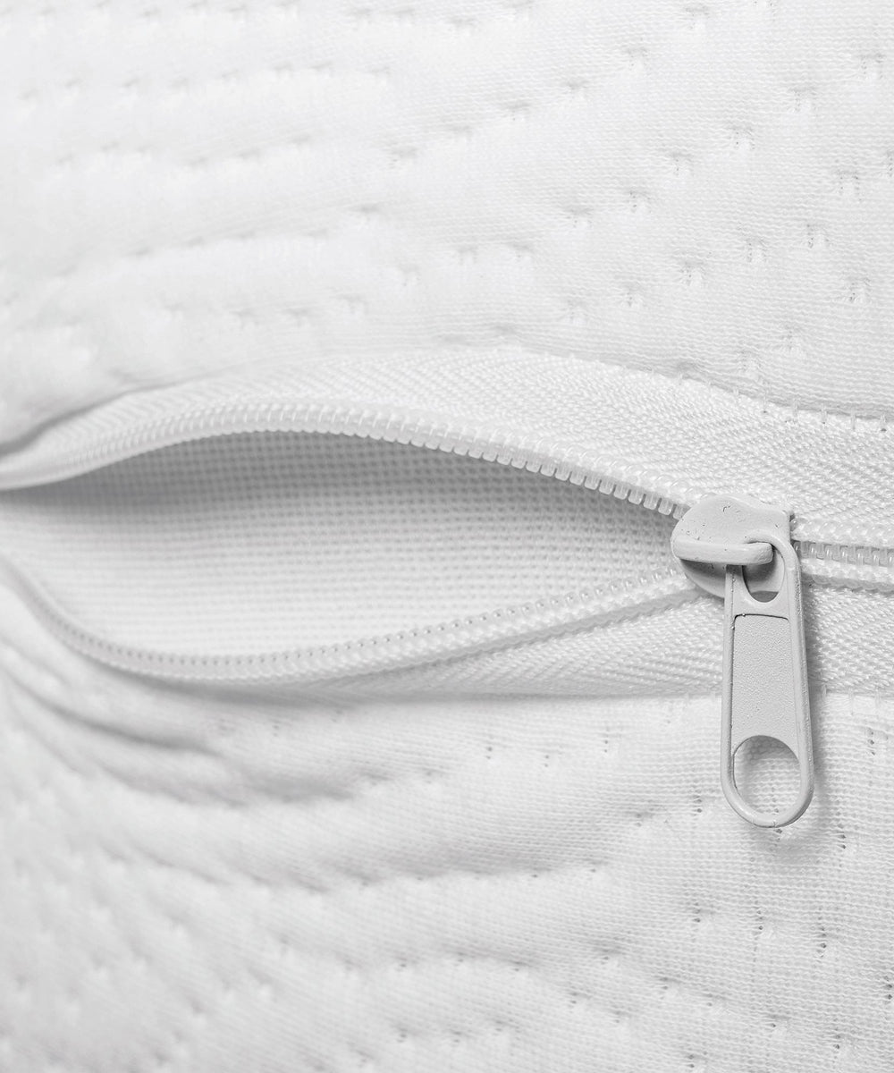 Close-up of the Dual Firm Crib Mattress's white fabric cover with a visible, partially unzipped zipper, highlighting detailed stitching and texture.
