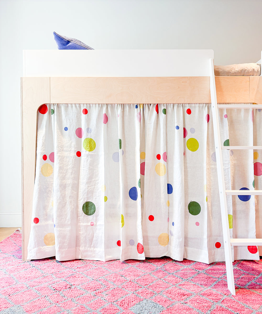 Printed Perch Bunk/Loft Linen Curtains featuring a white curtain with a colorful polka dot pattern hanging from the bottom of a loft bed.