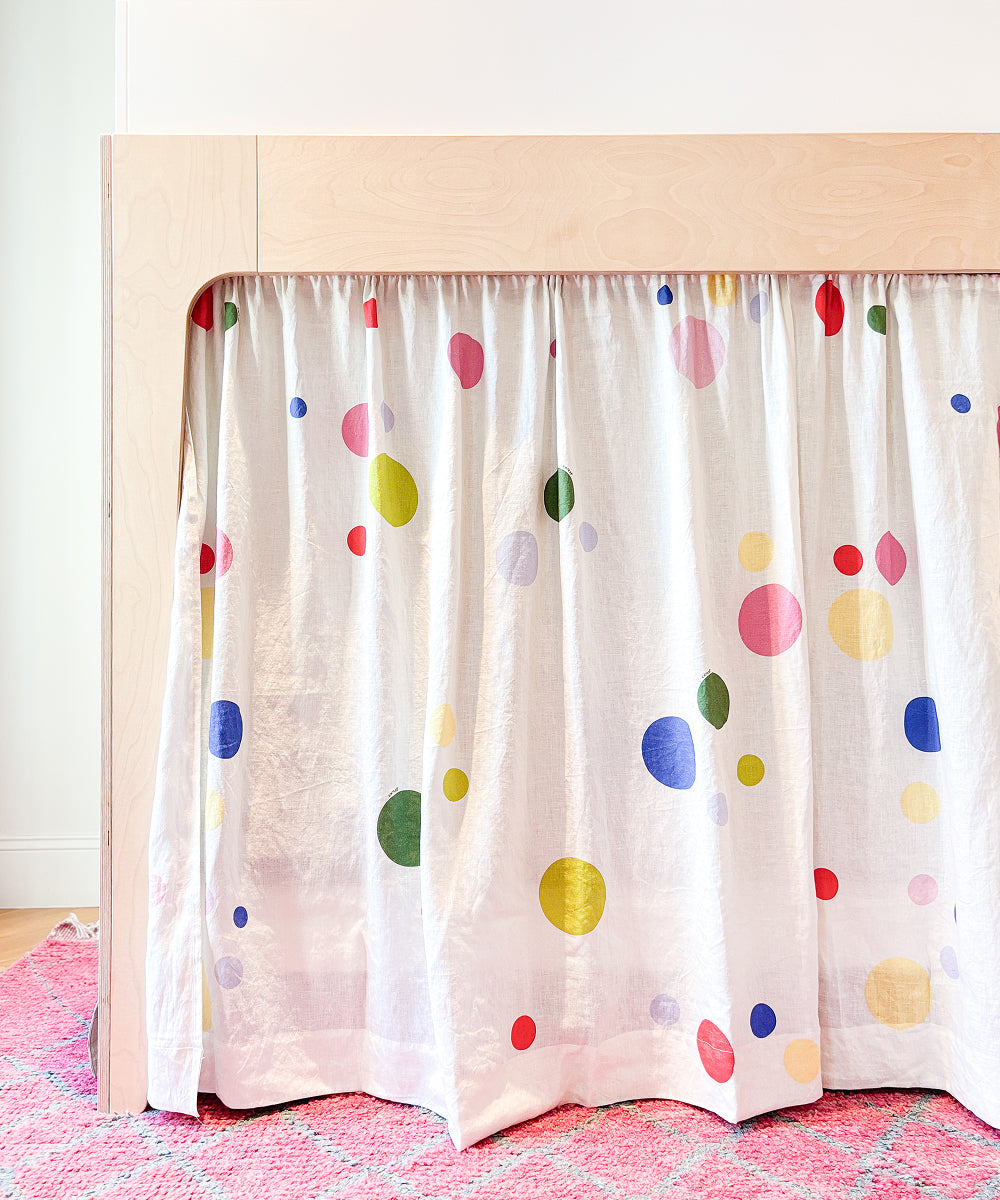 Printed Perch Bunk/Loft Linen Curtains featuring a white fabric with a colorful polka dot print, hanging from a wooden loft bed frame.