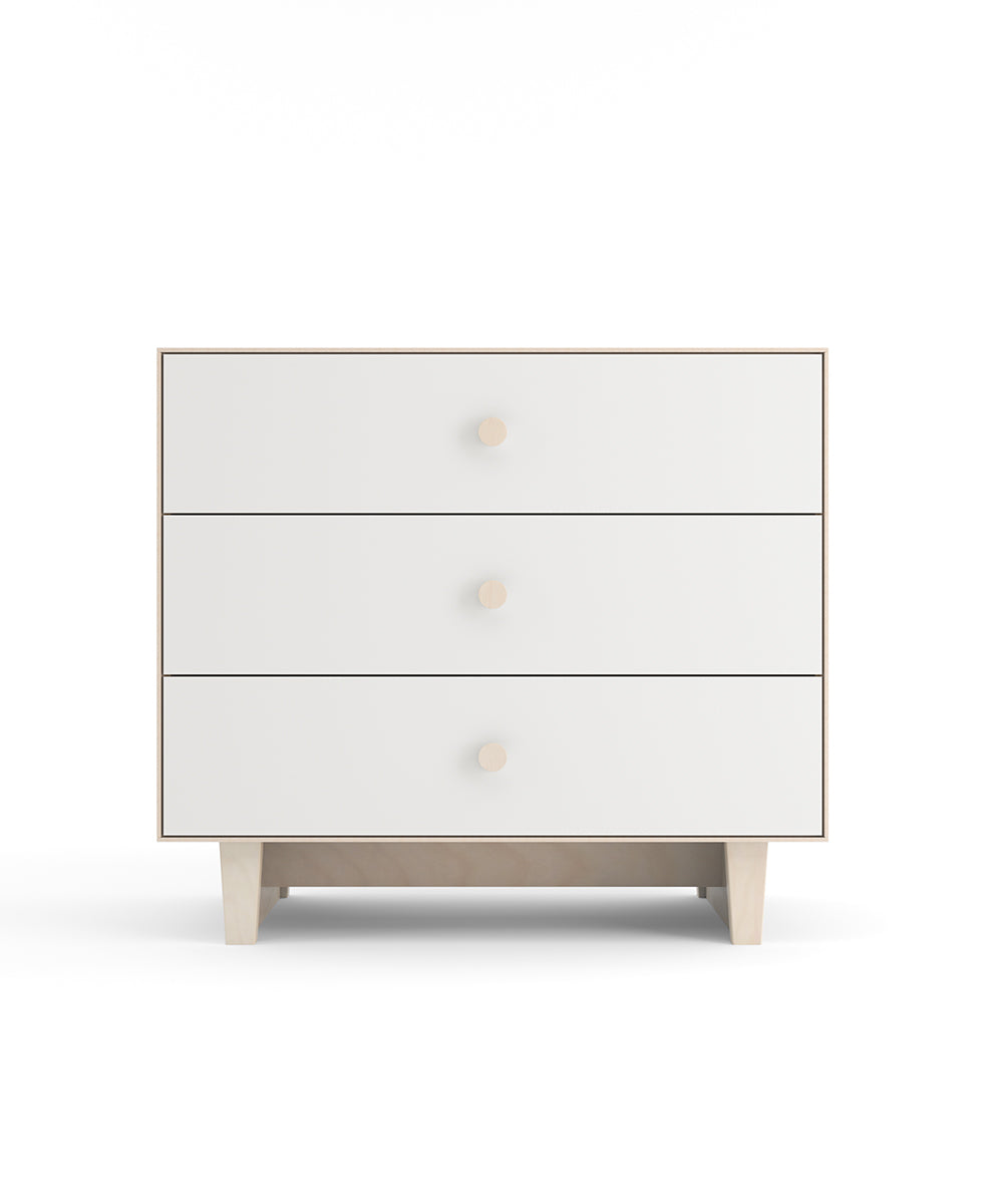 A white three-drawer dresser with round handles and short legs, viewed from the front.
