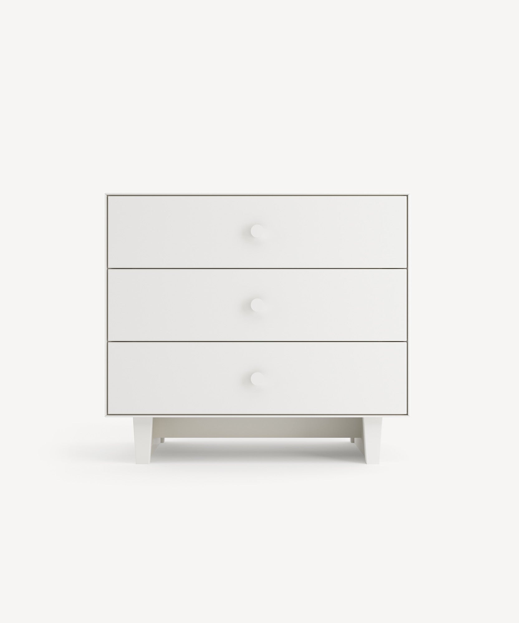 A wooden chest of drawers with three white drawers, each featuring a round knob, set on four rectangular legs against a white background.
