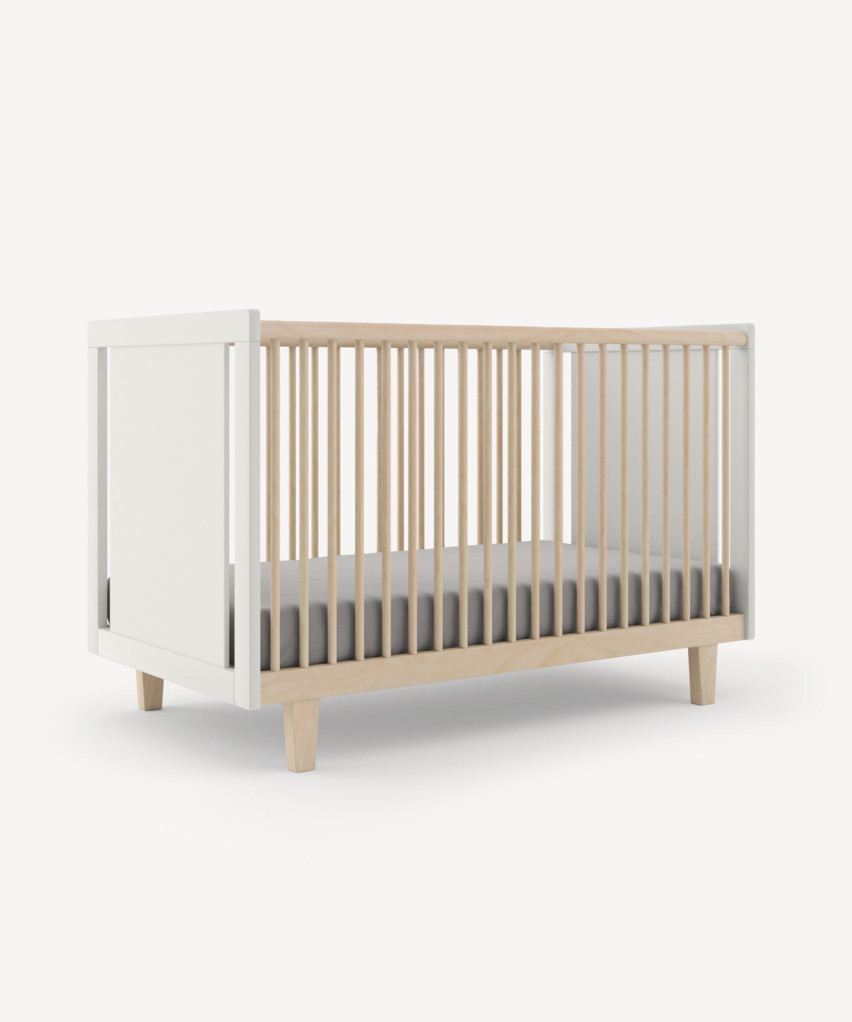 The Rhea Crib features a modern, minimalist design with light wood slats, white ends, and a dark mattress on a white background.