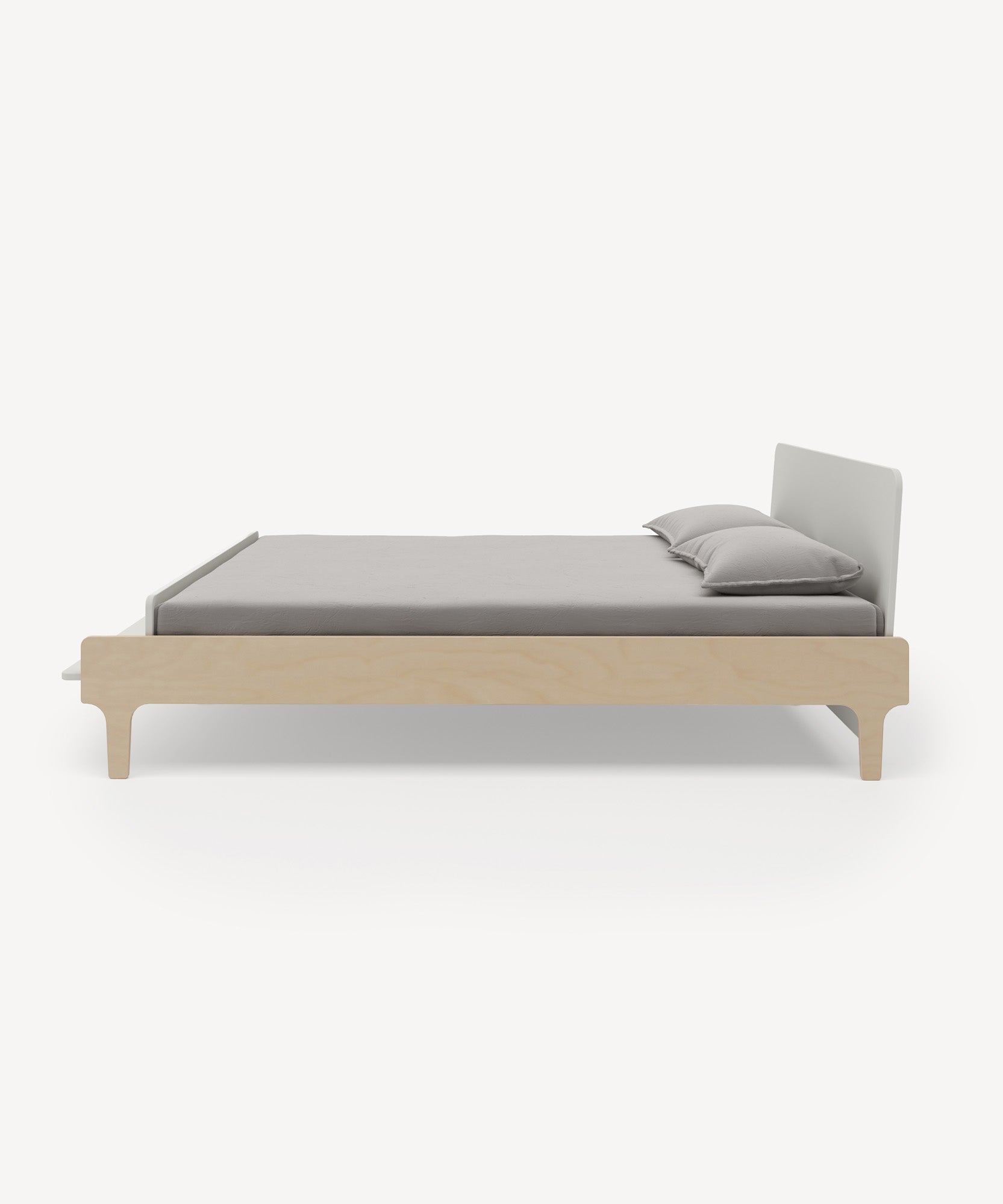 Side view of the River Full Bed, featuring a minimalist wooden frame with gray bedding and two pillows on a light background.