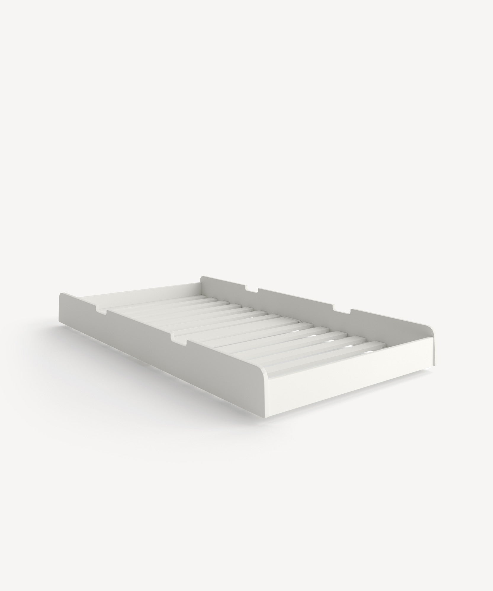 River Trundle Bed featuring a white, rectangular wooden tray with a slatted base against a plain background.