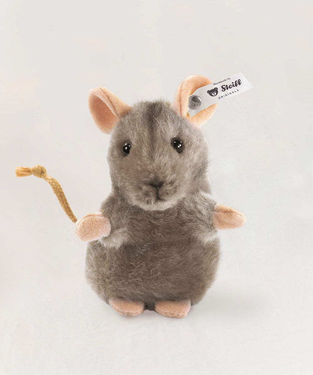 Le Mouse is a plush gray mouse toy featuring pink ears, pink feet, and an ear tag, displayed against a plain background.