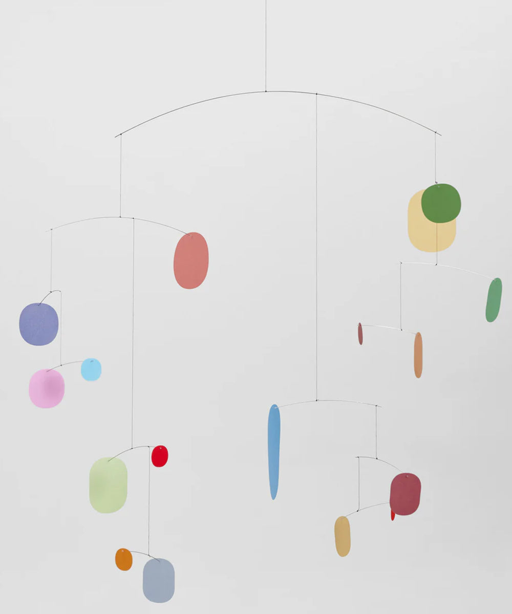 Colorful mobile with hanging shapes on a white background