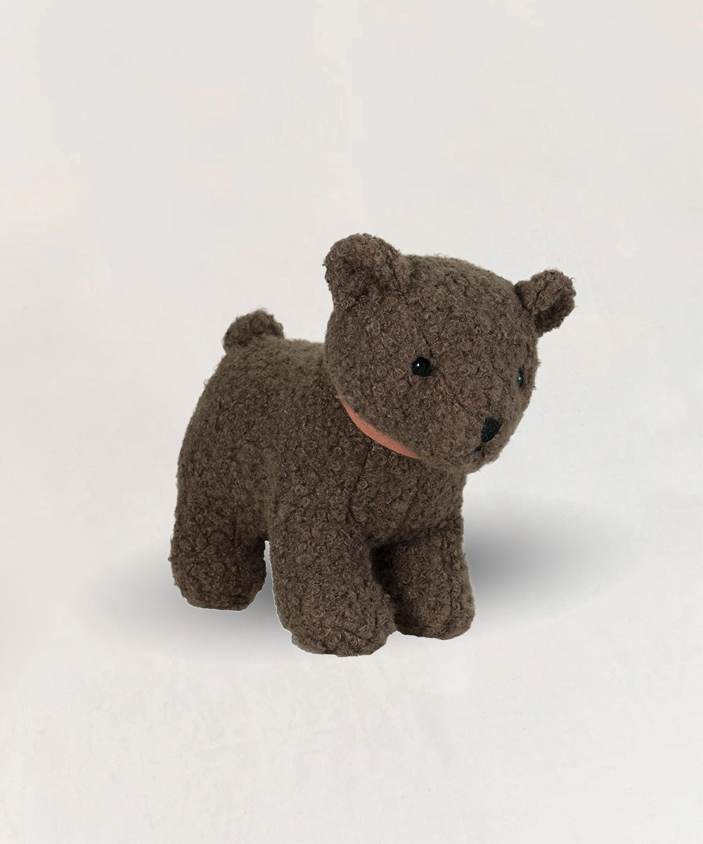 Eustache le Bear is a soft, brown plush teddy with black eyes and a small tail, pictured on a light background.
