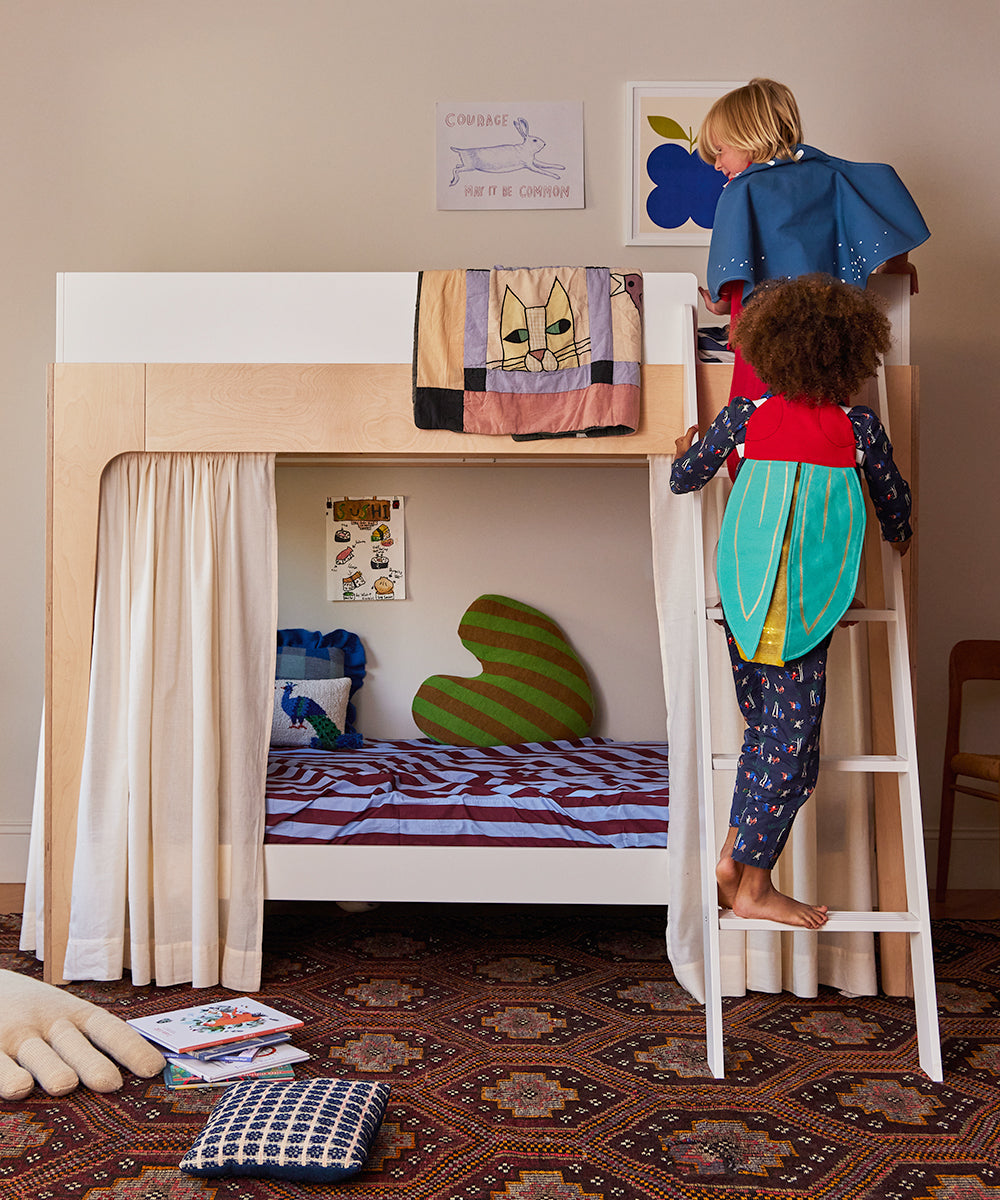 Two children wearing Le Firefly Wings Costumes climb a modern bunk bed in a cozy, decorated kids' room filled with toys and books.