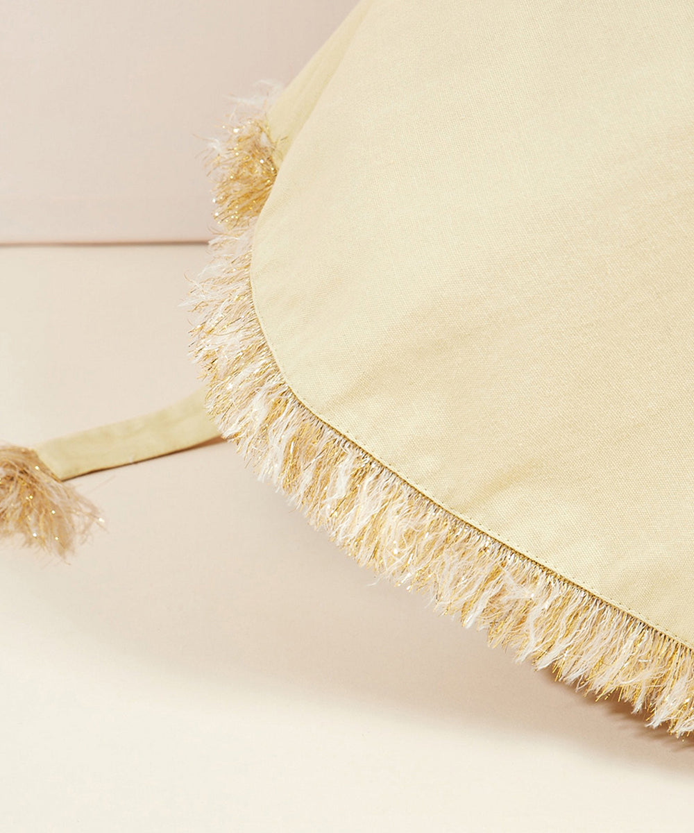 Close-up of the Lion Costume’s beige fringed fabric with tassels along the edge.