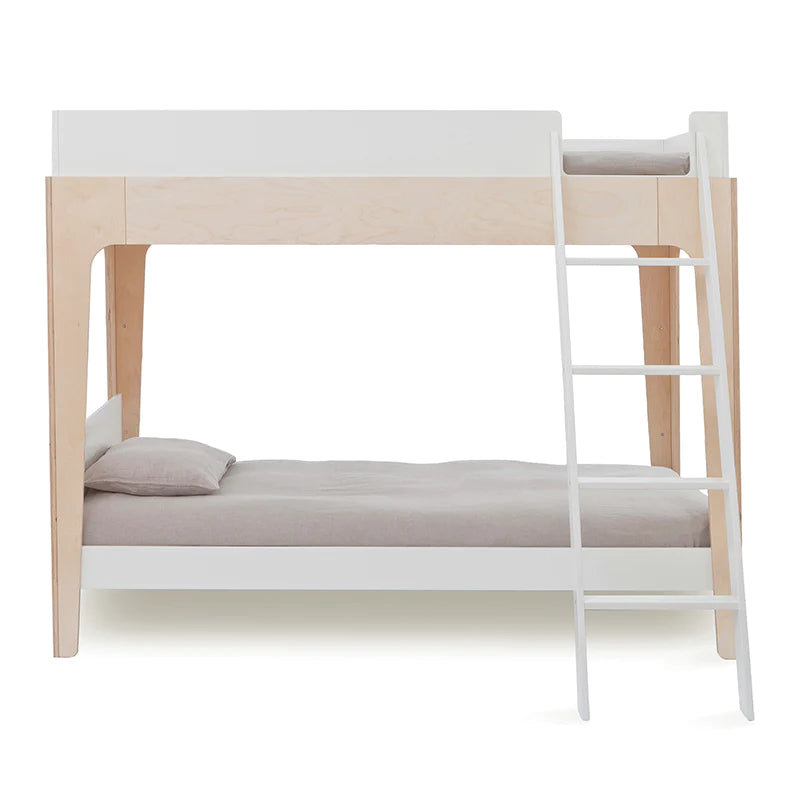 A wooden bunk bed with light wood framing, featuring a ladder on the right side. It has gray bedding on both the top and bottom bunks.