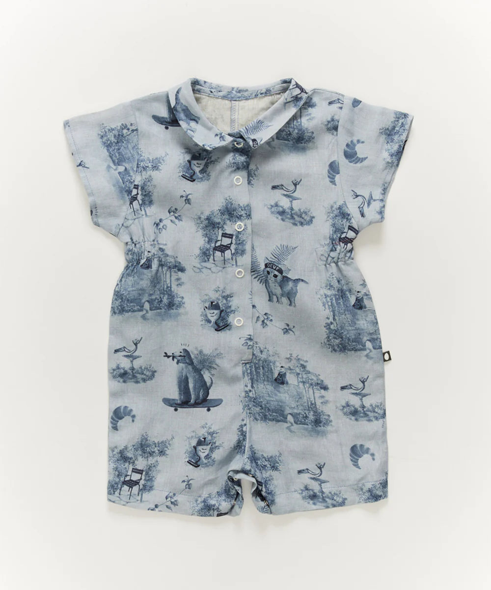 Blue baby romper with short sleeves, featuring a woodland animal and chair pattern in a toile style.