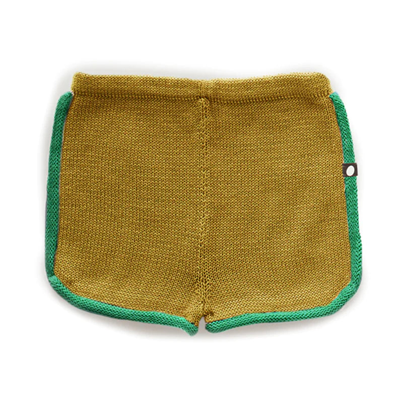 Yellow knit shorts with green trim and a small tag on the side, viewed from the back.