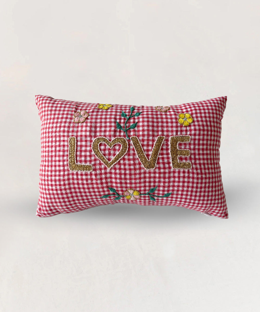 Red gingham Le Mini Embroidered Pillow with "LOVE" and floral embroidery on the front.