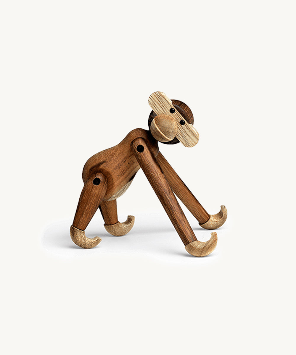Le Monkey by Kay Bojesen, a wooden toy with jointed limbs, stands on all fours against a plain white background.