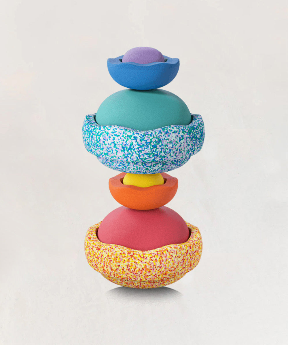 Stack of colorful nesting toys on white background