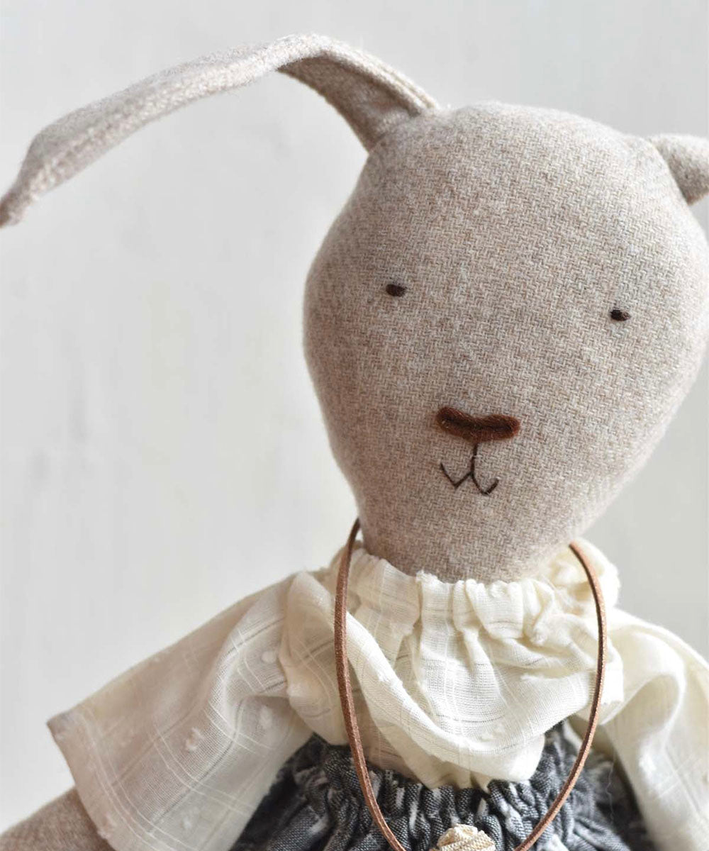 Ruthie le Rabbit - Ikat Skirt: Stuffed fabric bunny doll with simple embroidered face, white ruffled collar, and an ikat skirt.