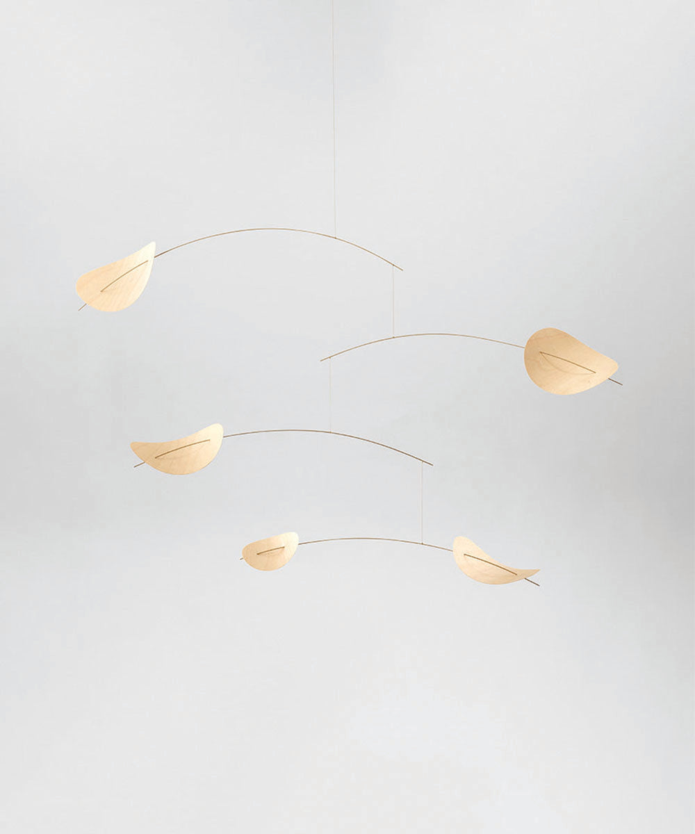 Le Drifting Clouds: a minimalist mobile featuring five wooden leaf shapes hanging from thin curved rods, set against a light gray background.