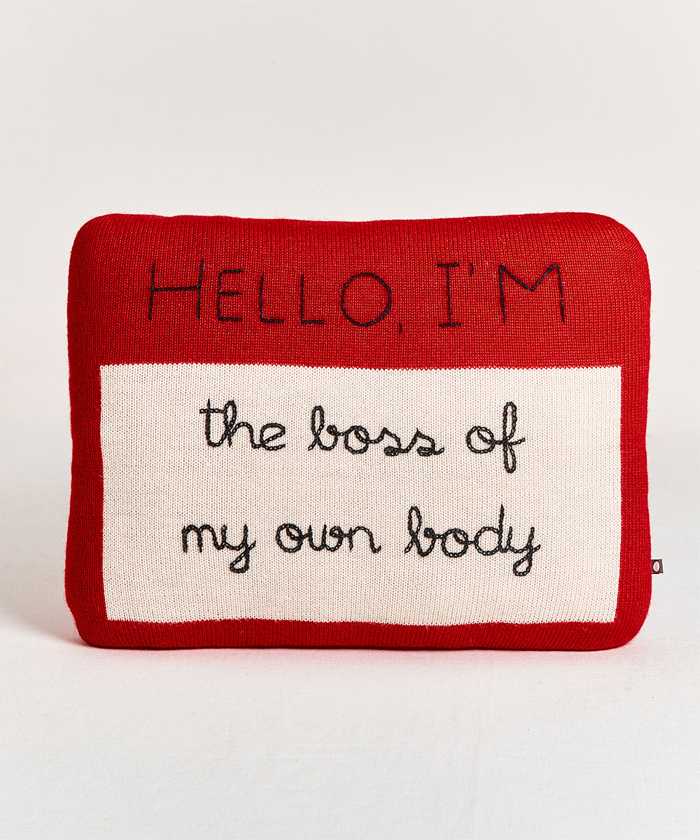 A Name Tag Pillow featuring "Hello, I'm the boss of my own body" on a red background.