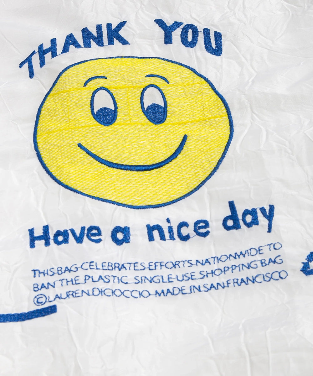 Le Thank You Tote: A white crinkled bag featuring a yellow smiley face with blue "Thank You" and "Have a nice day" text.