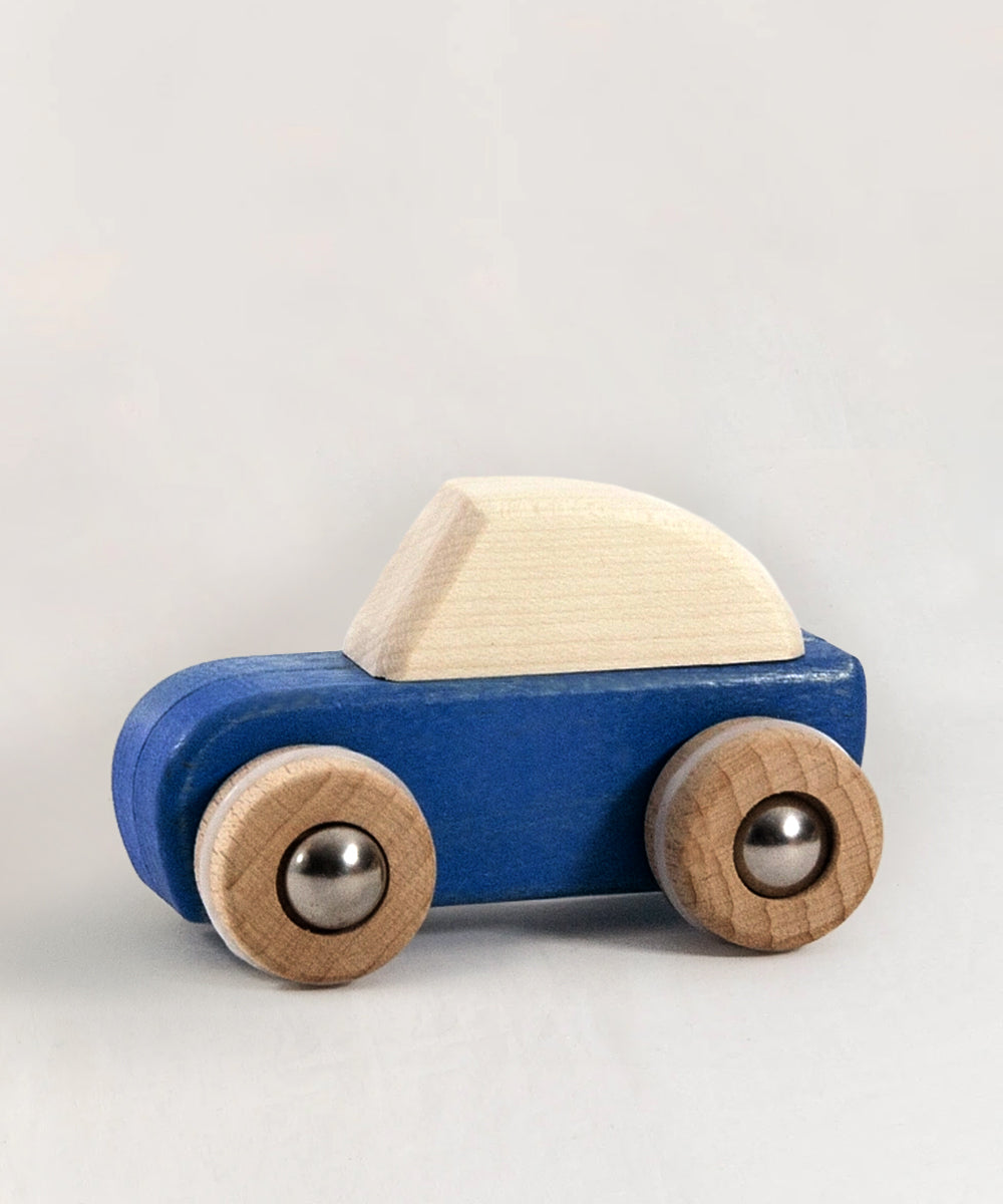 Le Pull-Back Car - Blue features a blue body, natural wood roof, and wheels with metal centers, shown on a plain background.
