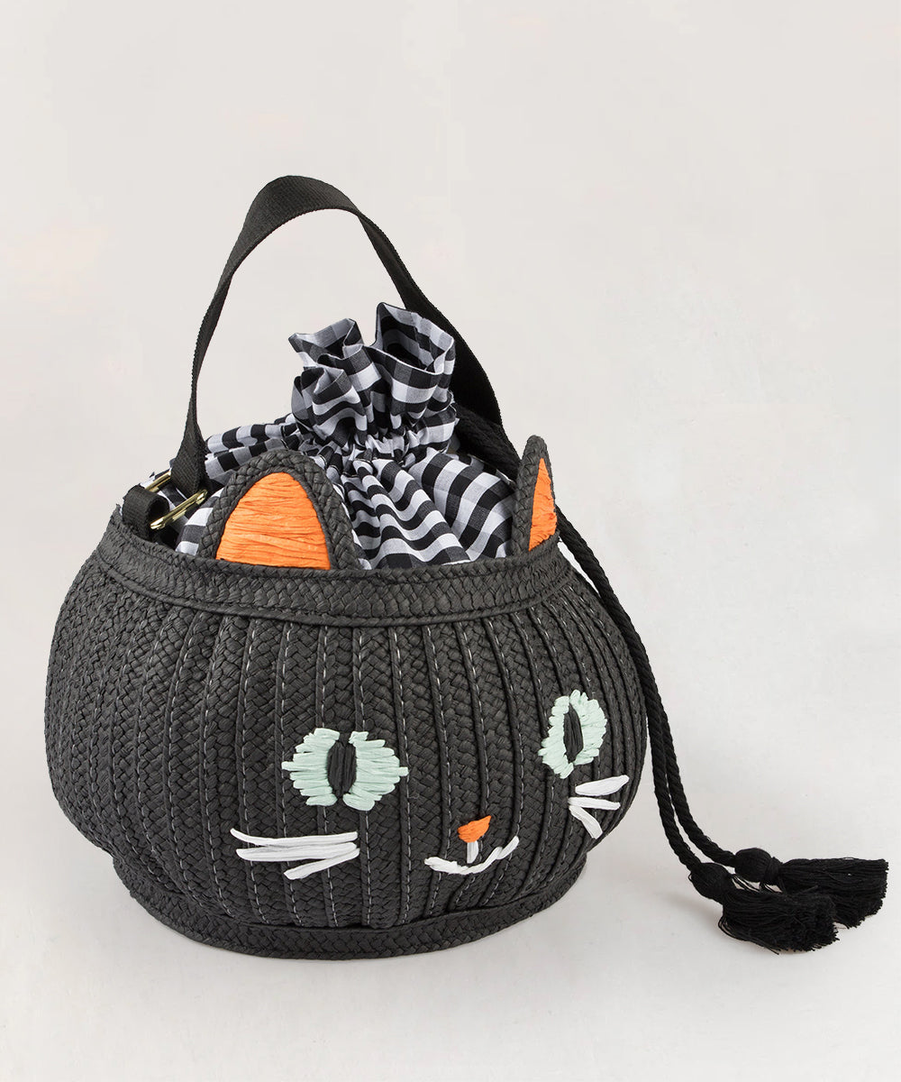 Le Cat Basket Bag: A round black bag featuring a cute cat face, orange ears, and a black-and-white checkered drawstring closure.