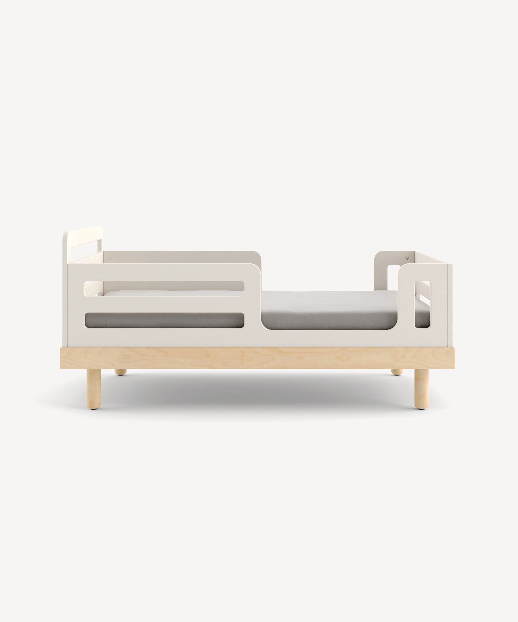 Classic Toddler Bed featuring white guardrails and light wooden legs on a plain background.