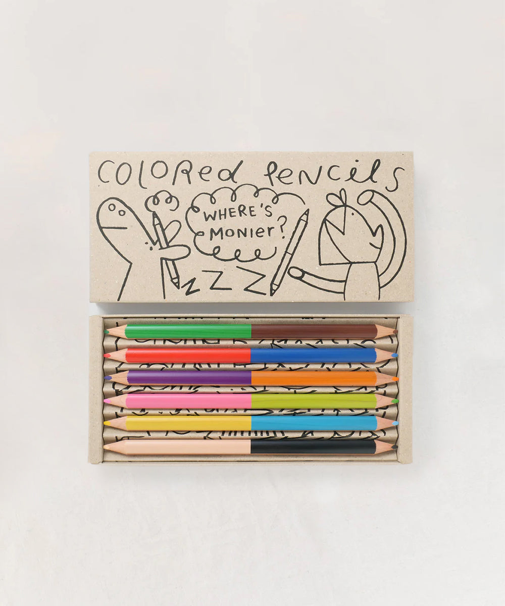 A box of Le Dream Colored Pencils features a playful doodle design on the lid with the text "Where’s Monier?".