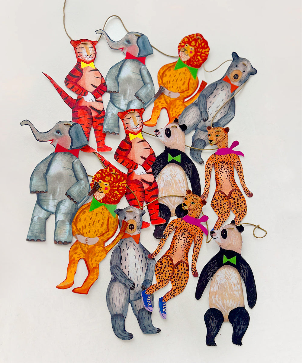 Le Garland - Animal Parade features colorful paper figures of elephants, tigers, pandas, and bears connected with string against a plain background.