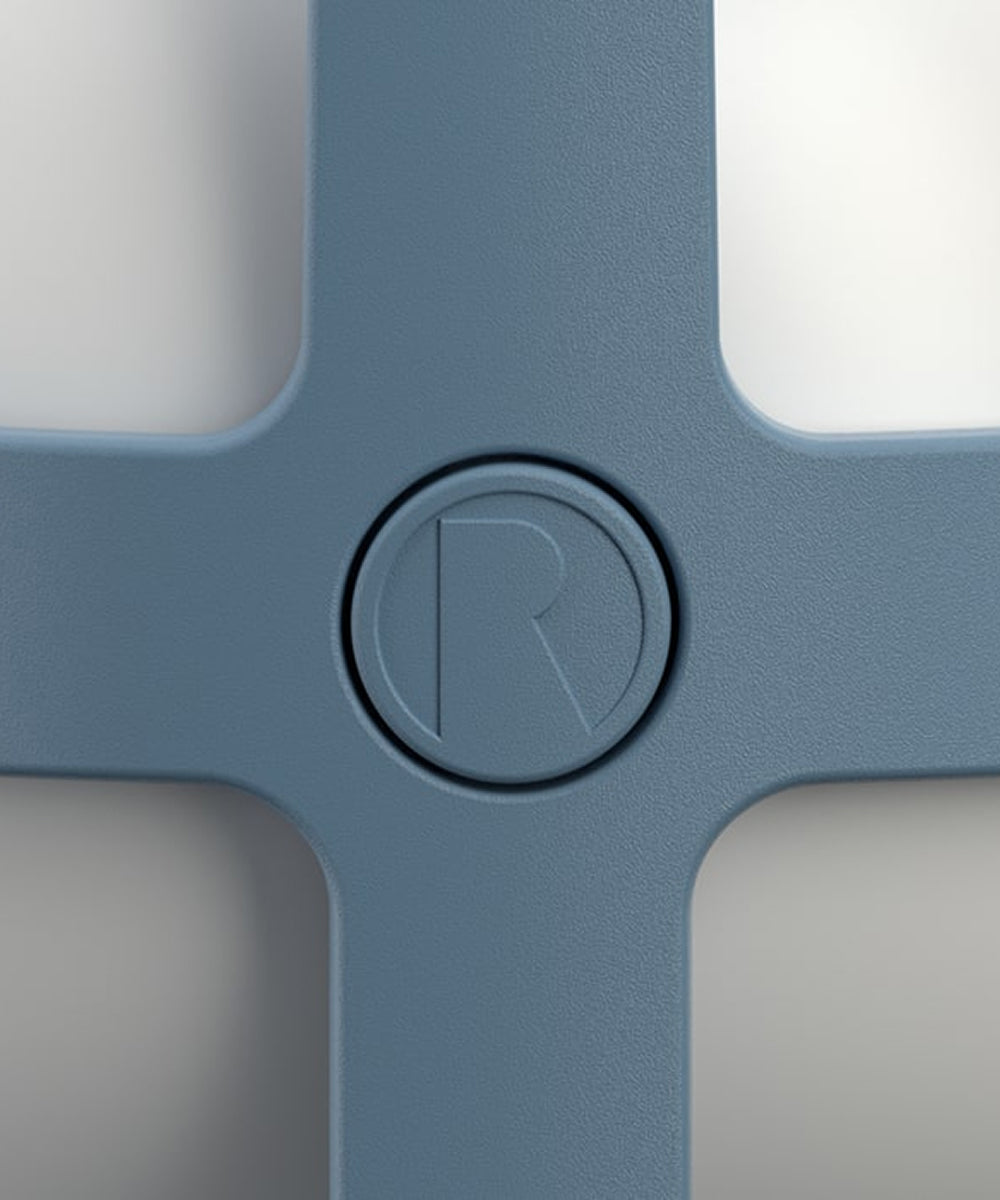 Close-up of a Rosendahl Soft Spot Solar Circular in sky blue, featuring a central circular logo embossed with the letter “R.”.