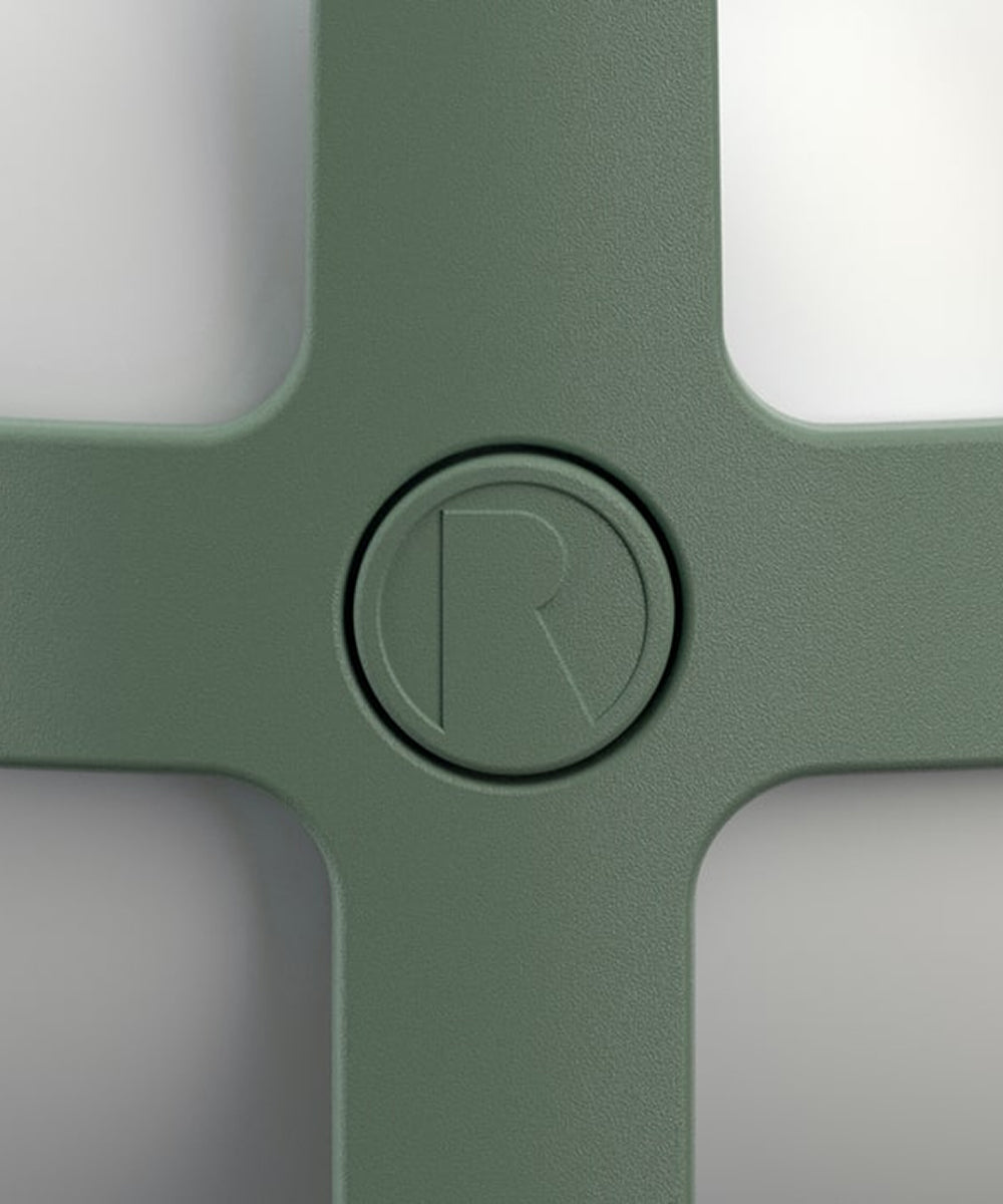 A close-up of the Rosendahl Soft Spot Solar Circular in pine green, featuring a matte finish and an embossed circular “R” logo at the center.
