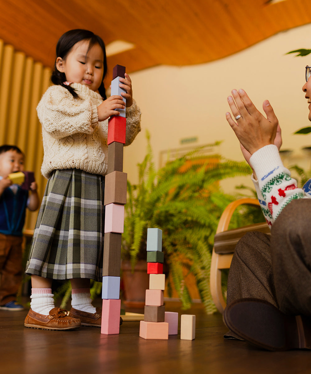 Child playing with building blocks in a home setting