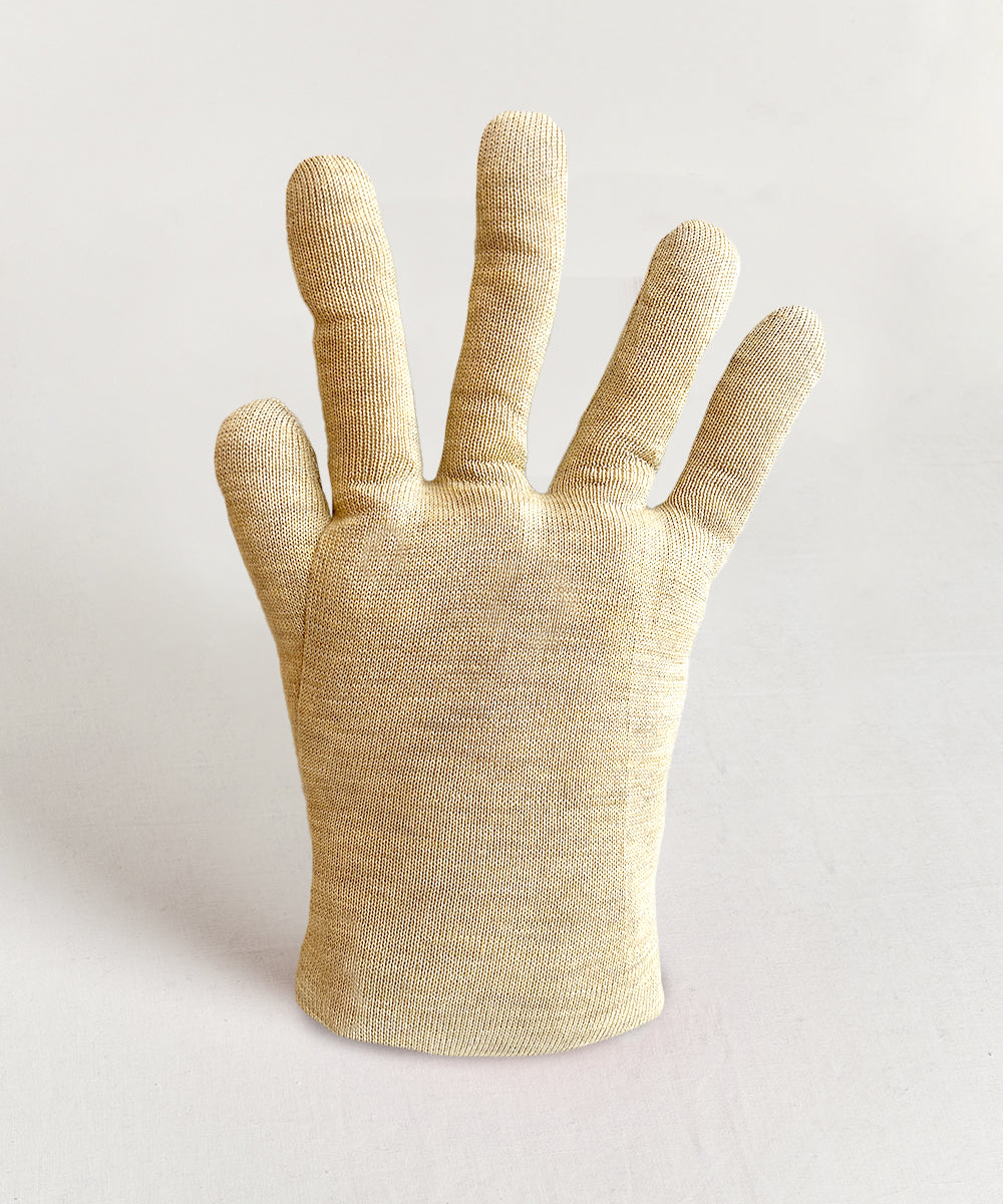 A beige Hand Pillow stands upright on a white surface, its fingers spread apart.