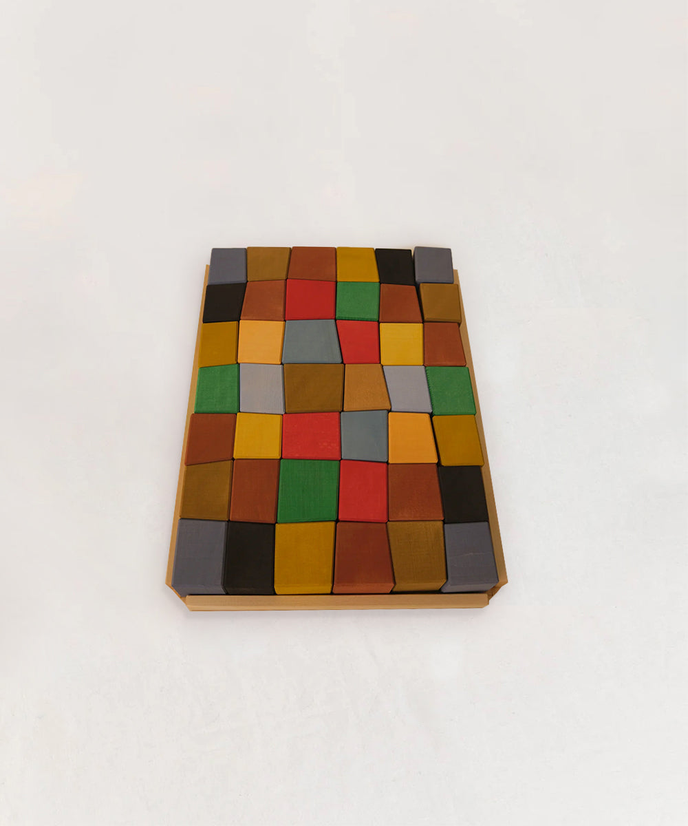 A Le Oddy Cubes - Mini tray holds colorful, rectangular wooden blocks neatly arranged in a grid on a white background.