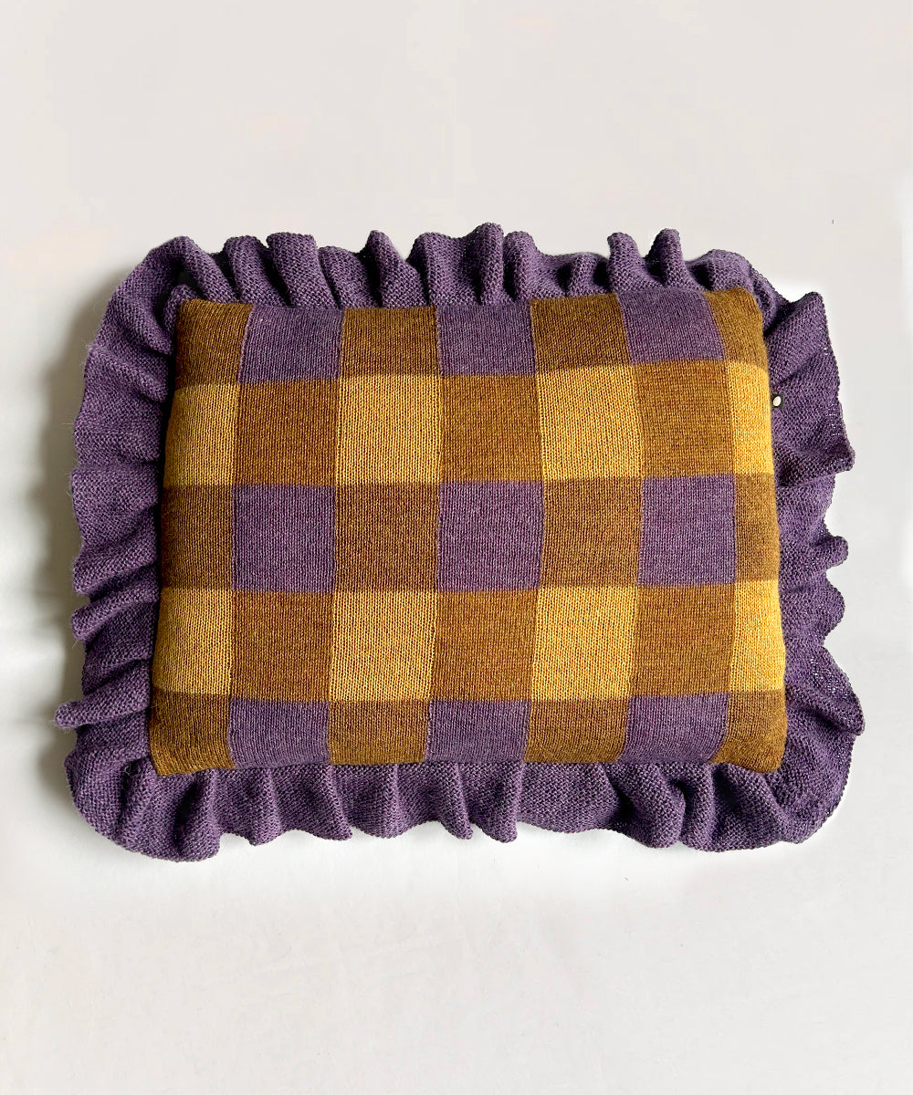 Gingham Ruffle Pillow featuring purple/brown checkers and ruffled edges on a light background.