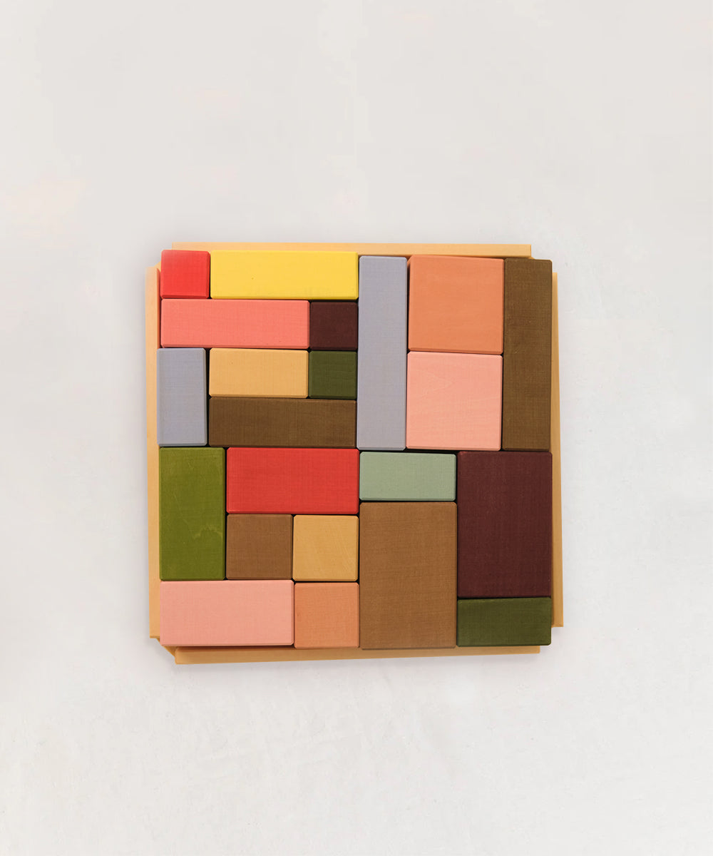 Le Rectangles: Vibrant rectangular and square blocks organized in a wooden tray, displayed against a white background.