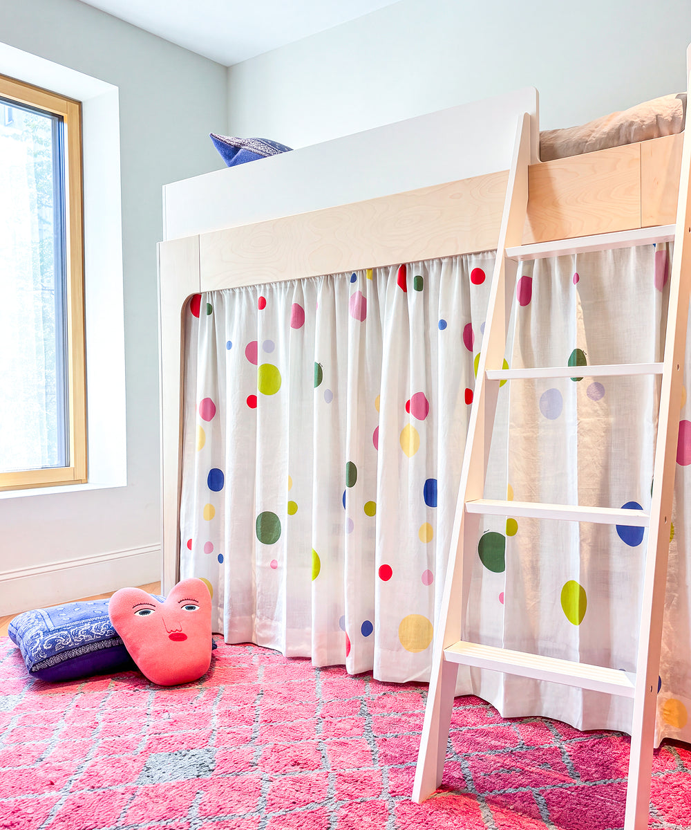 Printed Perch Bunk/Loft Linen Curtains with colorful polka dots hanging beneath a loft bed.