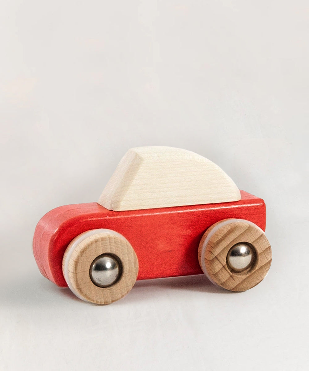 Le Pull-Back Car - Red: a red and white wooden toy car with four wooden wheels, shown on a neutral background.