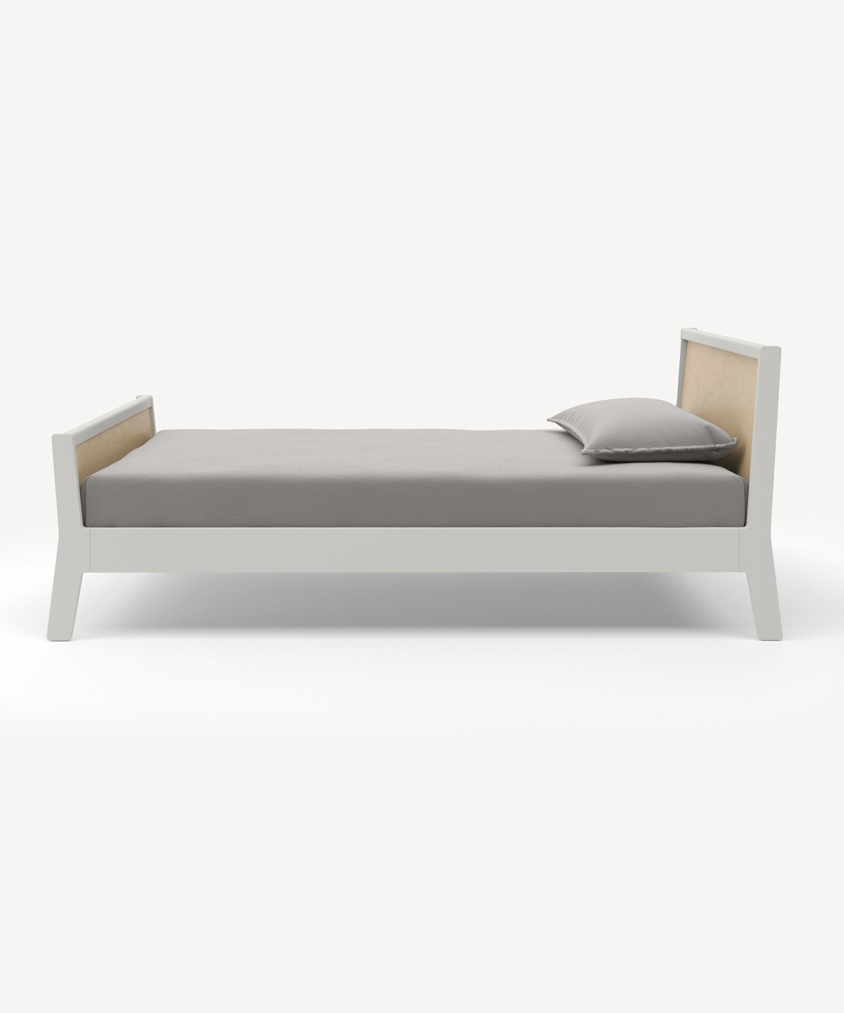 The Sparrow Twin Bed features a white frame, wooden headboard, and minimalist design with gray bedding and a pillow against a white backdrop.