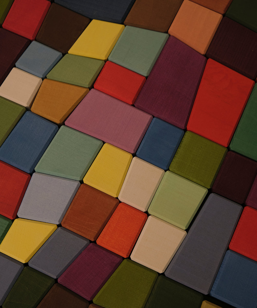 Le Oddy Cubes: vibrant, irregular wooden blocks arranged in a tight, mosaic-style pattern.