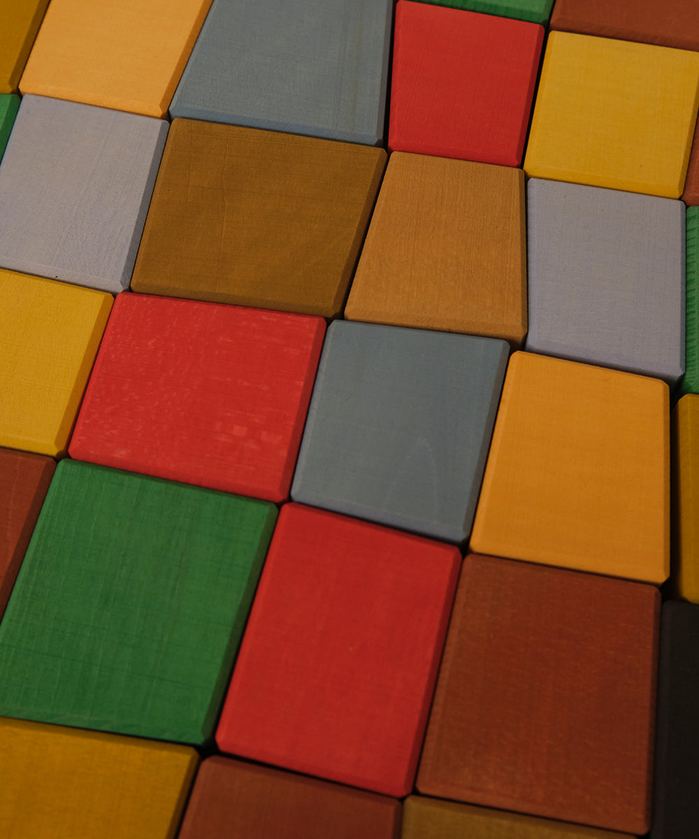 Le Oddy Cubes - Mini: Colorful wooden cubes arranged tightly in a geometric grid pattern.